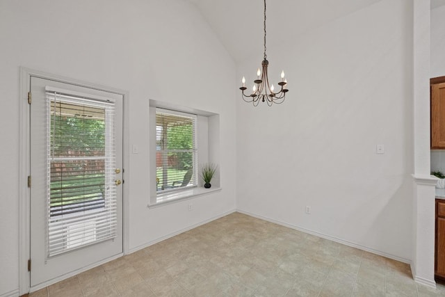 unfurnished dining area with lofted ceiling and a chandelier