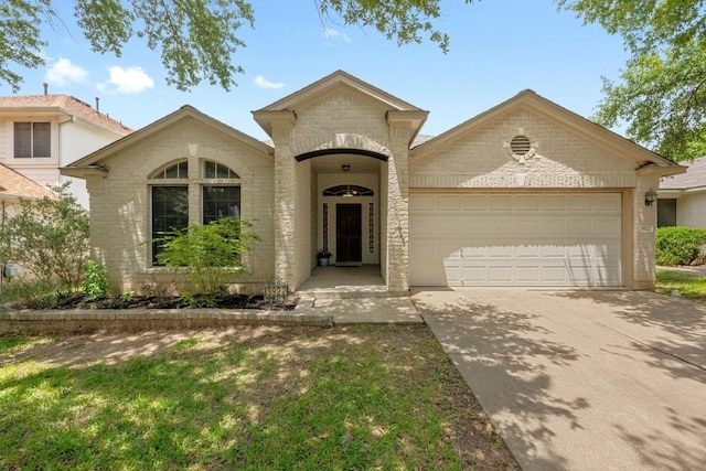 view of front facade with a garage, driveway, and brick siding