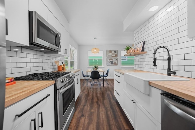 5916 Signal Pt, Austin, TX 78724 - kitchen featuring wood counters, stainless steel appliances, decorative backsplash, and a sink