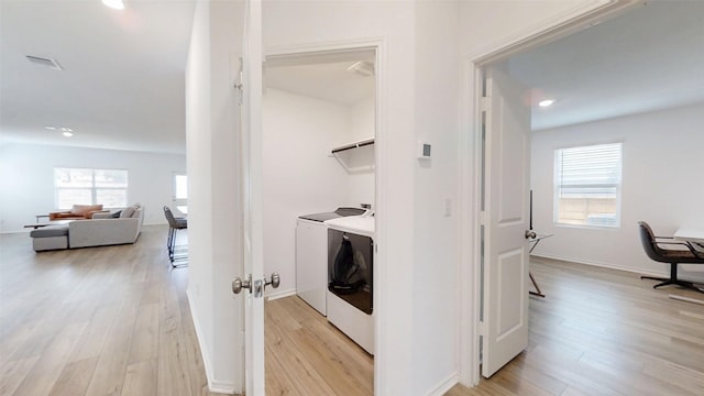 221 Mendoza, Kyle, TX 78640 - laundry area featuring independent washer and dryer, light wood-type flooring, recessed lighting, and baseboards