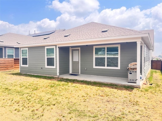 221 Mendoza, Kyle, TX 78640 - back of property featuring a patio, roof with shingles, and solar panels
