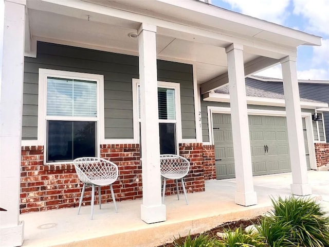 221 Mendoza, Kyle, TX 78640 - view of patio featuring a porch and a garage