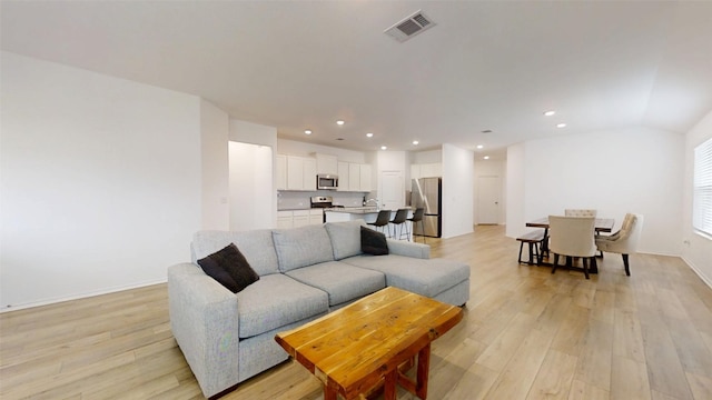 221 Mendoza, Kyle, TX 78640 - living room featuring light wood-style floors, recessed lighting, and baseboards