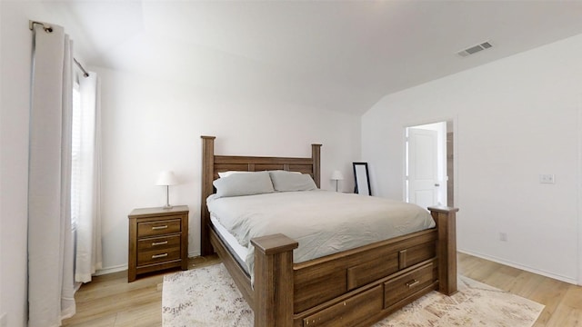 221 Mendoza, Kyle, TX 78640 - bedroom featuring light wood-style floors, lofted ceiling, and baseboards