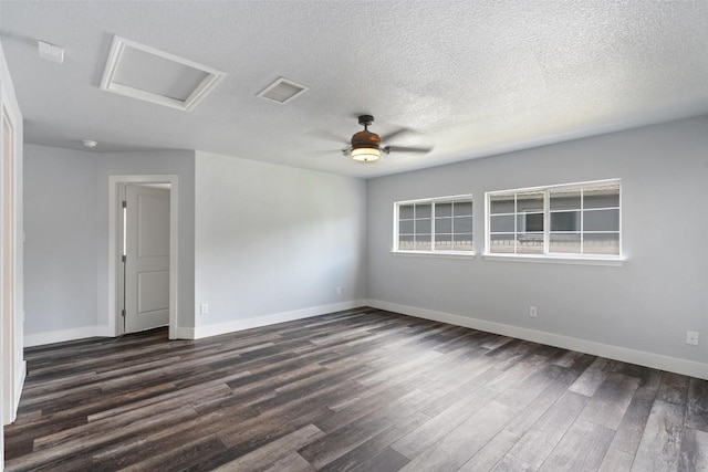 361 Whispering Hollow Dr, Kyle, TX 78640 - spare room featuring attic access, dark wood finished floors, baseboards, a ceiling fan, and a textured ceiling