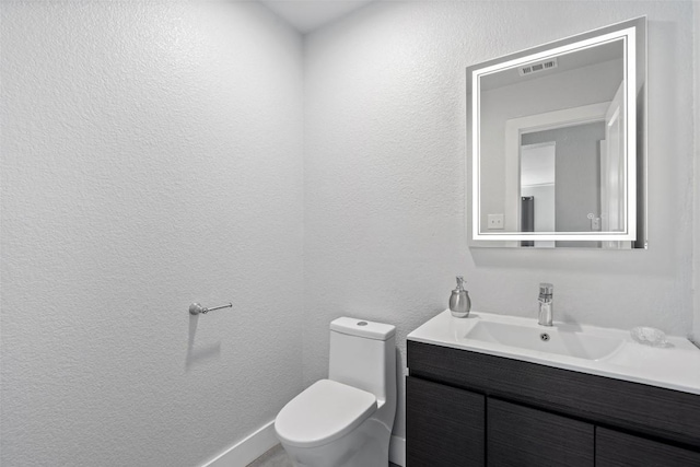 361 Whispering Hollow Dr, Kyle, TX 78640 - bathroom featuring toilet, vanity, and a textured wall