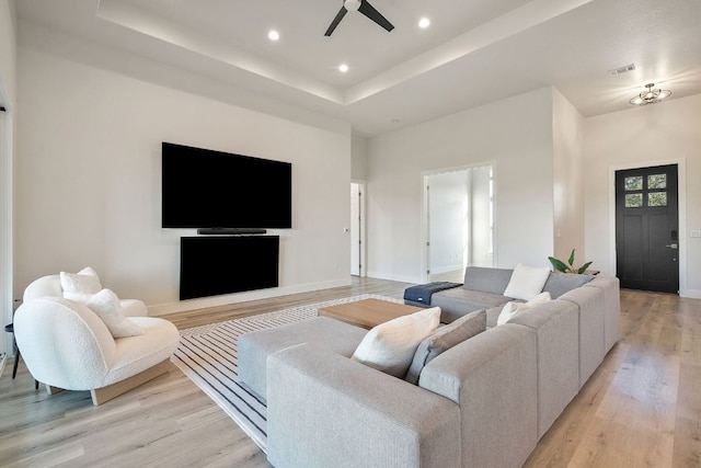 20704 Leaning Oak Dr, Lago Vista, TX 78645 - living area with light wood-style floors, a ceiling fan, recessed lighting, and a tray ceiling
