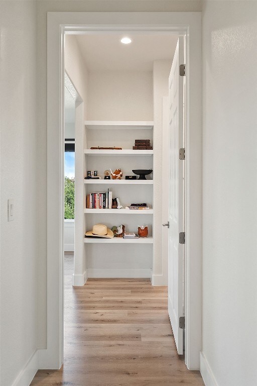 20704 Leaning Oak Dr, Lago Vista, TX 78645 - hallway featuring wood finished floors and built in features