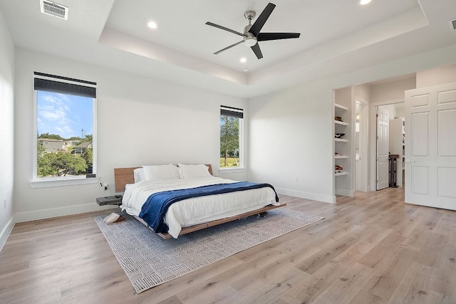 20704 Leaning Oak Dr, Lago Vista, TX 78645 - bedroom featuring a raised ceiling, light wood-style floors, recessed lighting, and ceiling fan