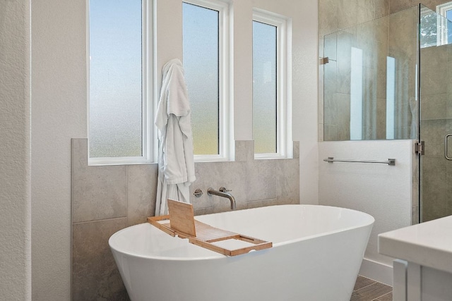 20704 Leaning Oak Dr, Lago Vista, TX 78645 - full bathroom with a stall shower, a freestanding bath, and wood finished floors