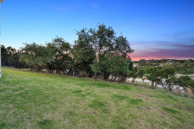 20704 Leaning Oak Dr, Lago Vista, TX 78645 - yard at dusk with a lawn