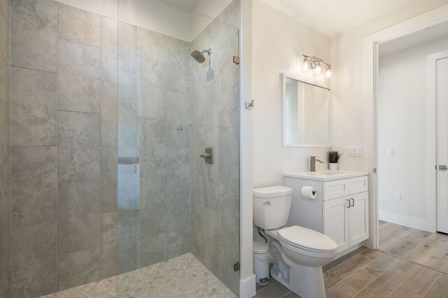 20704 Leaning Oak Dr, Lago Vista, TX 78645 - full bath featuring vanity, tiled shower, and wood finished floors