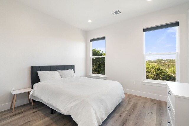 20704 Leaning Oak Dr, Lago Vista, TX 78645 - bedroom with light wood-type flooring and recessed lighting