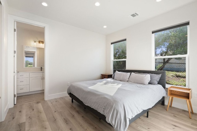 20704 Leaning Oak Dr, Lago Vista, TX 78645 - bedroom with light wood-type flooring, recessed lighting, and connected bathroom