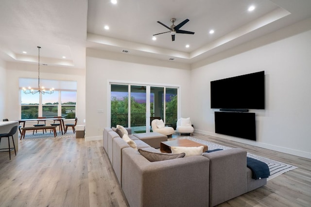 20704 Leaning Oak Dr, Lago Vista, TX 78645 - living room featuring a tray ceiling, a chandelier, recessed lighting, light wood finished floors, and a towering ceiling