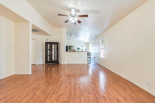 821 Sweet Leaf Ln, Pflugerville, TX 78660 - unfurnished living room featuring a ceiling fan, light wood-type flooring, lofted ceiling, and baseboards