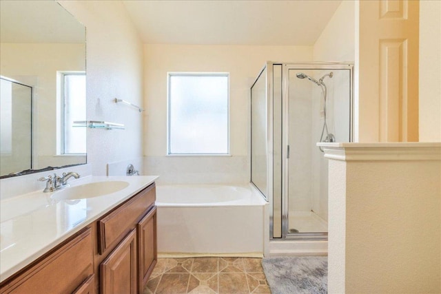 full bathroom with a stall shower, vanity, a bath, and tile patterned floors