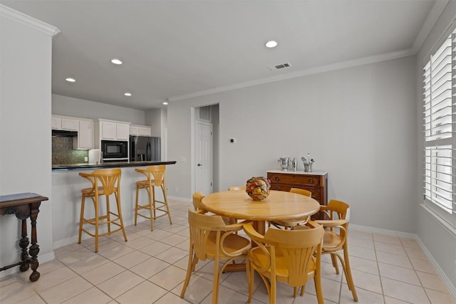 11558 Spicewood Pkwy Unit 7, Austin, TX 78750 - dining room featuring light tile patterned floors, crown molding, recessed lighting, and baseboards