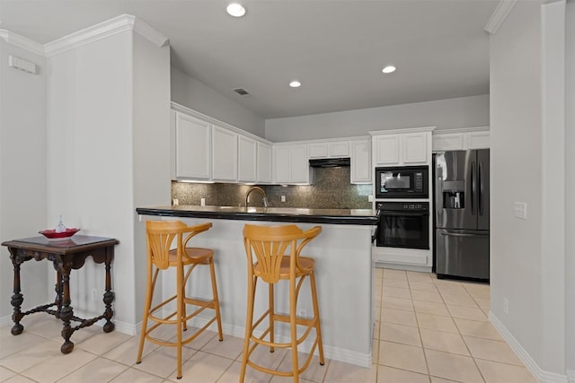 11558 Spicewood Pkwy Unit 7, Austin, TX 78750 - kitchen with black appliances, dark countertops, decorative backsplash, white cabinets, and recessed lighting