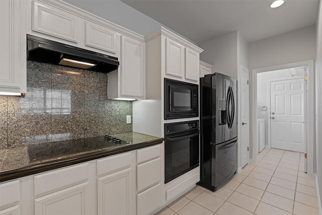 11558 Spicewood Pkwy Unit 7, Austin, TX 78750 - kitchen with black appliances, under cabinet range hood, light tile patterned flooring, dark countertops, and white cabinets
