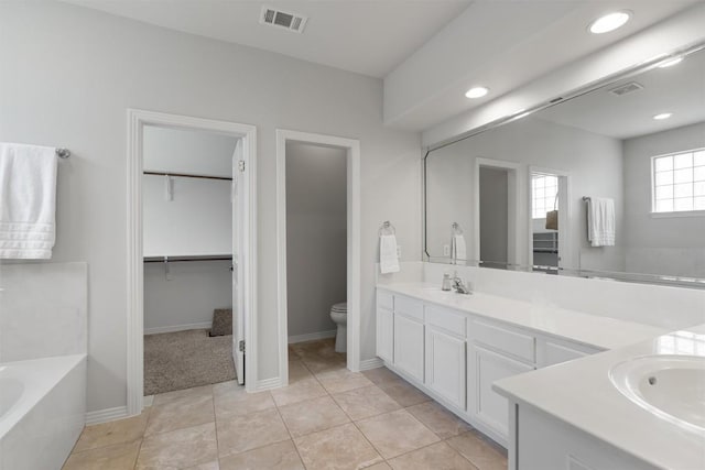 11558 Spicewood Pkwy Unit 7, Austin, TX 78750 - bathroom with toilet, double vanity, a bath, a spacious closet, and recessed lighting