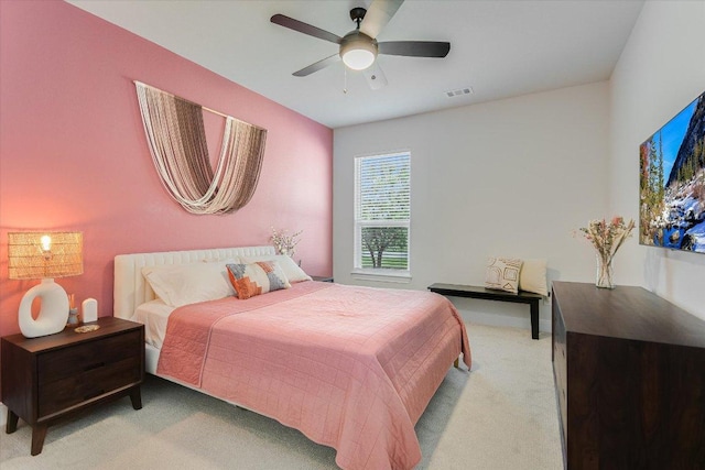 bedroom featuring light carpet and ceiling fan