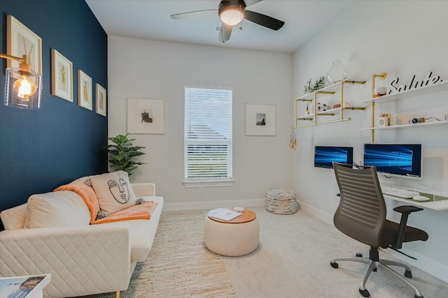 carpeted home office featuring ceiling fan and baseboards