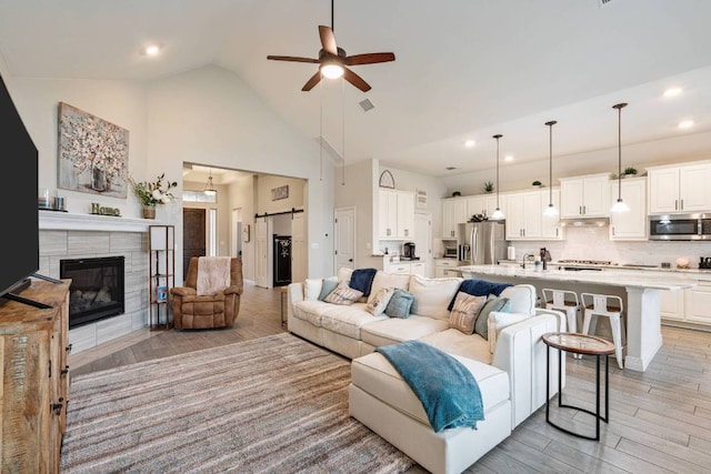 512 Bell Boot Pass, Georgetown, TX 78626 - living area featuring ceiling fan, light wood finished floors, recessed lighting, high vaulted ceiling, and a fireplace