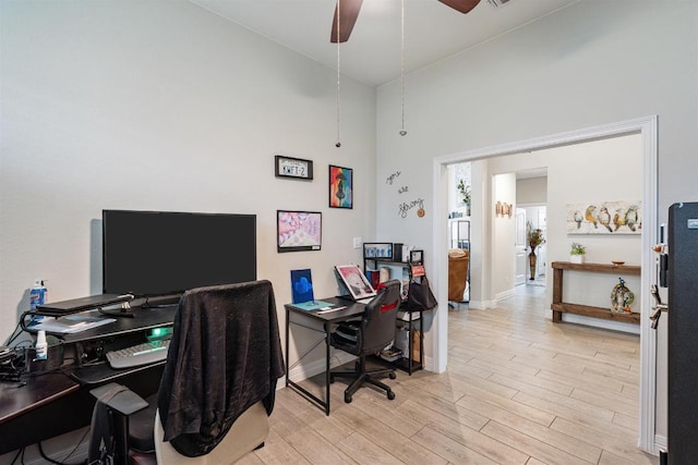 512 Bell Boot Pass, Georgetown, TX 78626 - home office with light wood finished floors, a ceiling fan, a high ceiling, and baseboards