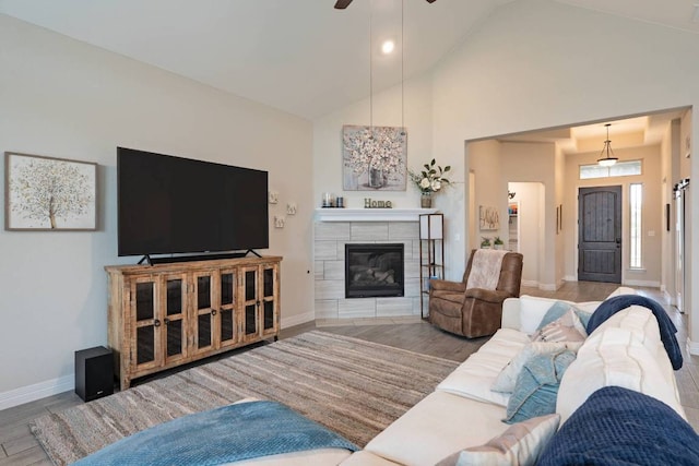 512 Bell Boot Pass, Georgetown, TX 78626 - living area with baseboards, high vaulted ceiling, a ceiling fan, a fireplace, and wood finished floors
