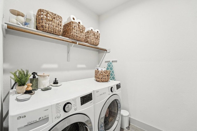 laundry room featuring washer and dryer and baseboards