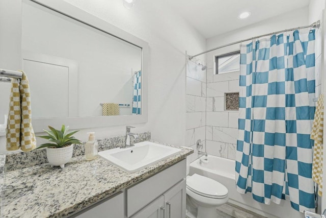 bathroom featuring toilet, vanity, and shower / tub combo