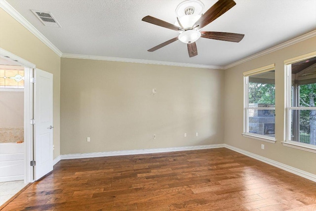 214 Yellow Rose Trl SE, Georgetown, TX 78633 - unfurnished room featuring wood finished floors, crown molding, a ceiling fan, and baseboards