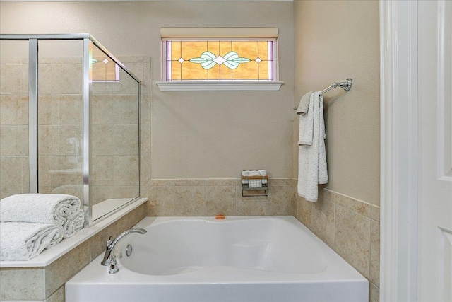 214 Yellow Rose Trl SE, Georgetown, TX 78633 - bathroom with a bath and tiled shower