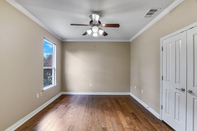 214 Yellow Rose Trl SE, Georgetown, TX 78633 - empty room featuring a ceiling fan, dark wood-style floors, baseboards, and ornamental molding