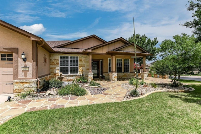 214 Yellow Rose Trl SE, Georgetown, TX 78633 - view of front of property with stone siding, a front yard, and board and batten siding