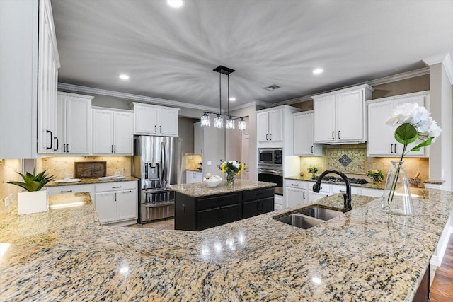 214 Yellow Rose Trl SE, Georgetown, TX 78633 - kitchen with a sink, stainless steel appliances, crown molding, light stone counters, and a center island