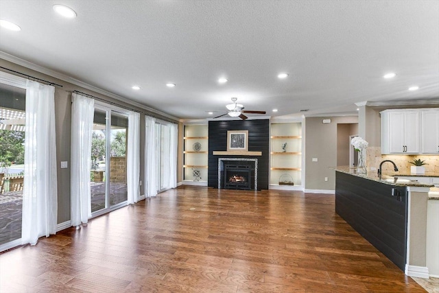 214 Yellow Rose Trl SE, Georgetown, TX 78633 - living area with ornamental molding, ceiling fan, dark wood-style floors, recessed lighting, and baseboards