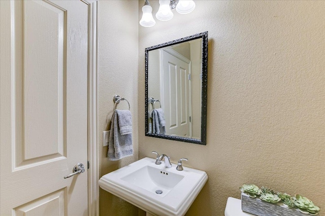 214 Yellow Rose Trl SE, Georgetown, TX 78633 - bathroom with a sink, a textured wall, and toilet