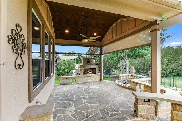 214 Yellow Rose Trl SE, Georgetown, TX 78633 - view of patio / terrace featuring an outdoor stone fireplace, ceiling fan, and fence