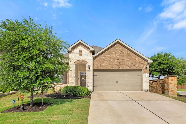 french country inspired facade with an attached garage, driveway, stone siding, a front lawn, and brick siding
