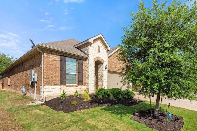 view of front facade with stone siding, a garage, a front lawn, and brick siding