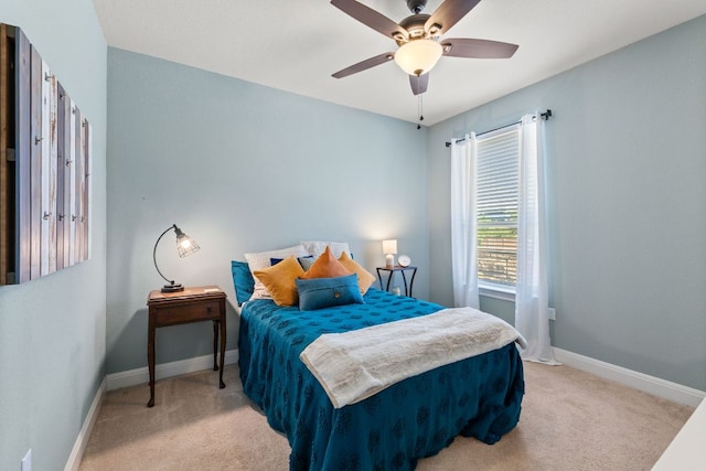 bedroom with light carpet, baseboards, and ceiling fan