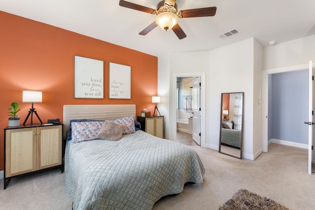 carpeted bedroom featuring baseboards, ceiling fan, and ensuite bathroom