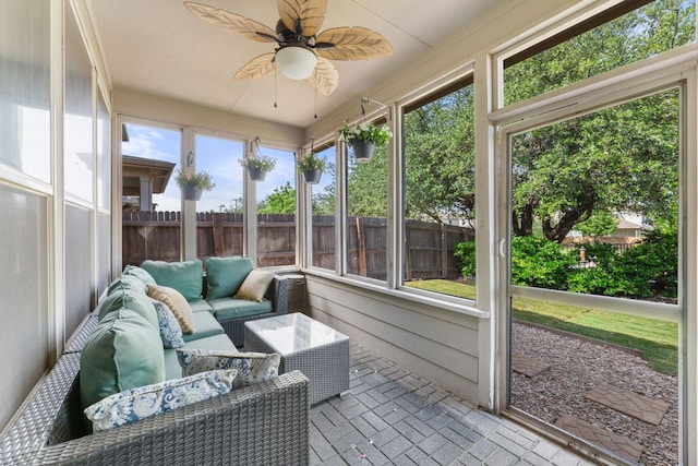 sunroom with ceiling fan and an outdoor hangout area