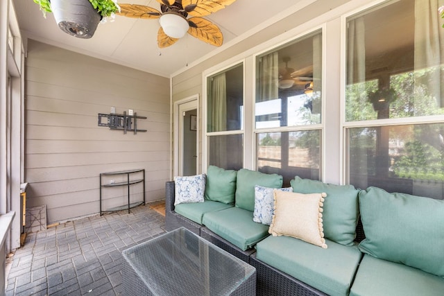 sunroom with ceiling fan, plenty of natural light, and an outdoor living space