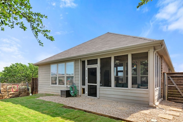 back of property with a sunroom