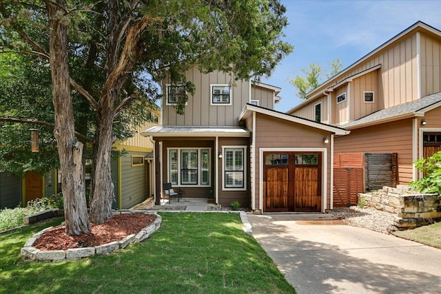 4608 Windy Brook Dr Unit B, Austin, TX 78723 - view of front of house featuring board and batten siding, concrete driveway, an attached garage, and a front yard