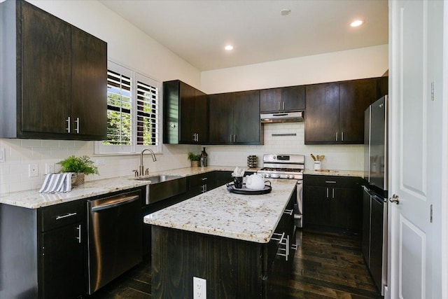 4608 Windy Brook Dr Unit B, Austin, TX 78723 - kitchen with stainless steel appliances, a center island, a sink, under cabinet range hood, and tasteful backsplash