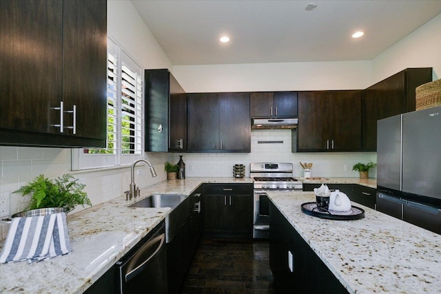 4608 Windy Brook Dr Unit B, Austin, TX 78723 - kitchen with appliances with stainless steel finishes, under cabinet range hood, a sink, light stone counters, and dark wood-type flooring